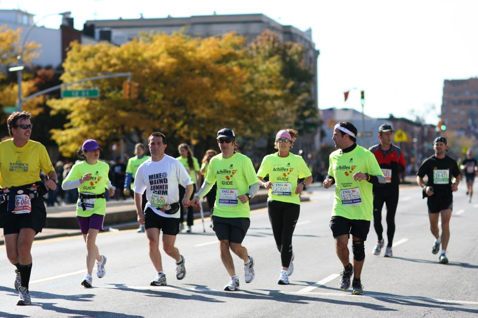 Mike and guiding team running during 2011 New York City Marathon photo