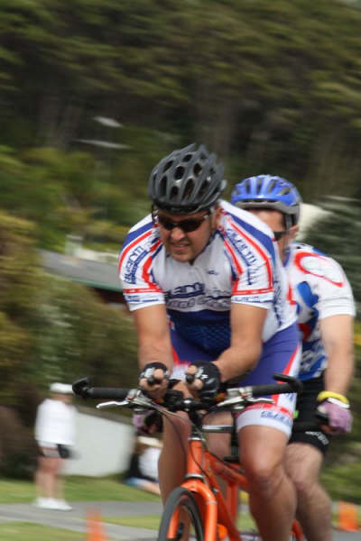 Mike and Lloyd cycling on tandem bike while competing in the Panasonic People's Triathlon November 2008 photo